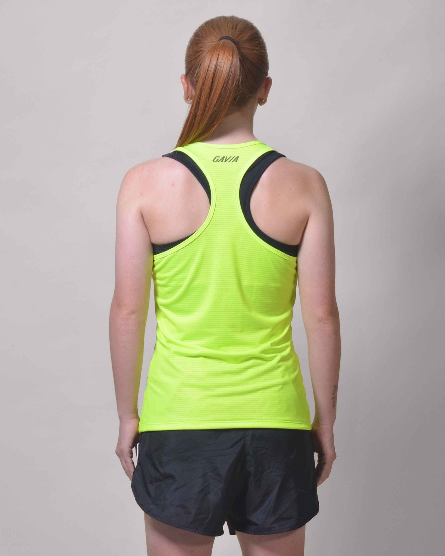 Polera Running Gavia Flow Green - Camiseta de correr sin mangas. Mujer (Amarillo)